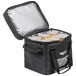 A black Vollrath insulated catering bag with a 6-compartment divider holding six large beverages.