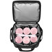 A black Vollrath insulated cooler with six large pink beverages inside.