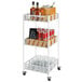 A white metal Cal-Mil Portland merchandiser cart with plastic inserts holding bottles and glasses.