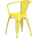 A Lancaster Table & Seating distressed yellow metal arm chair with a backrest.