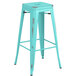 A Lancaster Table & Seating distressed seafoam metal barstool with a square top.
