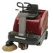 A red and black Minuteman Kleen Sweep rider floor sweeper with a round brush.