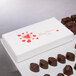 A white 2-piece Valentine's Day candy box with red hearts on it.