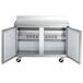 An Avantco stainless steel worktop freezer with two doors open.