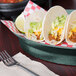 A plate of tacos in a HS Inc. jalapeno oval deli server on a table.