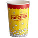 A yellow and red paper cup with the words "Freshly Popped Popcorn" on it.
