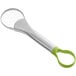 A silver and green plastic Choice avocado slicer with a handle.