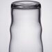 A Libbey juice glass filled with a clear liquid on a white background.