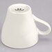 A close-up of the white handle of a Tuxton Europa cappuccino mug.