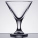 A clear plastic martini glass with a short stem and a small base.