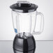 A black Waring blender with a clear jar and black lid.