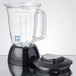 A Waring blender with a clear copolyester jar, lid, and blade on a table.