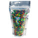 A clear plastic zip top stand-up pouch filled with colorful candy.
