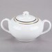 A white porcelain sugar bowl with gold trim and lid.