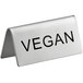 A stainless steel double sided table tent sign that says "Vegan" in black text.