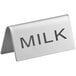 A stainless steel double sided table tent sign that says "Milk" on it.