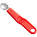 A Choice tomato corer with a red plastic handle.