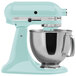 A blue KitchenAid tilt head mixer with a stainless steel bowl.