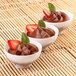 Three Fineline white plastic bowls of chocolate pudding with strawberries and mint.