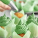 A close-up of Chefmaster Leaf Green Liqua-Gel food coloring used to make green frosting on cupcakes.