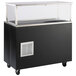 A black and silver Vollrath refrigerated cold food station with glass breath guard on a counter.