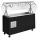 A black and silver Vollrath refrigerated food cart with open storage and a countertop.