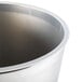 A silver plastic liner for a round wastebasket.