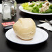A round white Thunder Group Nustone Melamine plate with a salad on it.