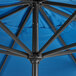 The bottom of a blue Lancaster Table & Seating umbrella with black metal poles.