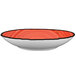 A white porcelain pasta bowl with a red rim.