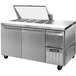 A Continental Refrigerator stainless steel sandwich prep table with two doors and a glass top.