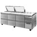 A stainless steel Continental Refrigerator food prep table with six drawers.