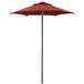 A Lancaster Table & Seating terracotta umbrella on a pole.