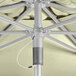 A close up of a Lancaster Table & Seating canvas umbrella with metal wires.