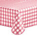 A red and white checkered Choice vinyl table cover with a textured gingham pattern and flannel back on a table.