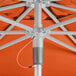 A Lancaster Table & Seating papaya umbrella with a metal pole and wires.