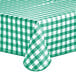 A green and white checkered Choice vinyl table cover on an outdoor table.