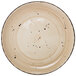 An International Tableware Rotana wheat coupe porcelain plate with black speckles.