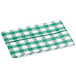 A green and white checkered vinyl table cover on a table.