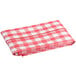A red and white checkered Choice vinyl table cover on a table.
