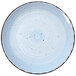 A white International Tableware porcelain plate with black dots on it.