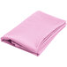A pink folded cloth table cover.