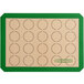 A green and white Baker's Mark silicone baking mat with circles for macarons.