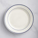 An Acopa ivory stoneware plate with blue lines.