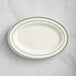 An ivory oval platter with green lines.