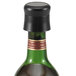 A wine bottle with a black plastic Vollrath wine stopper in it.