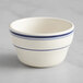 An Acopa ivory stoneware bouillon cup with blue bands.