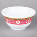 A white melamine bowl with red and yellow oriental designs.