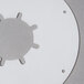 A circular white metal plate with holes in it.