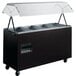 A black Vollrath portable hot food station with clear covers over the wells.
